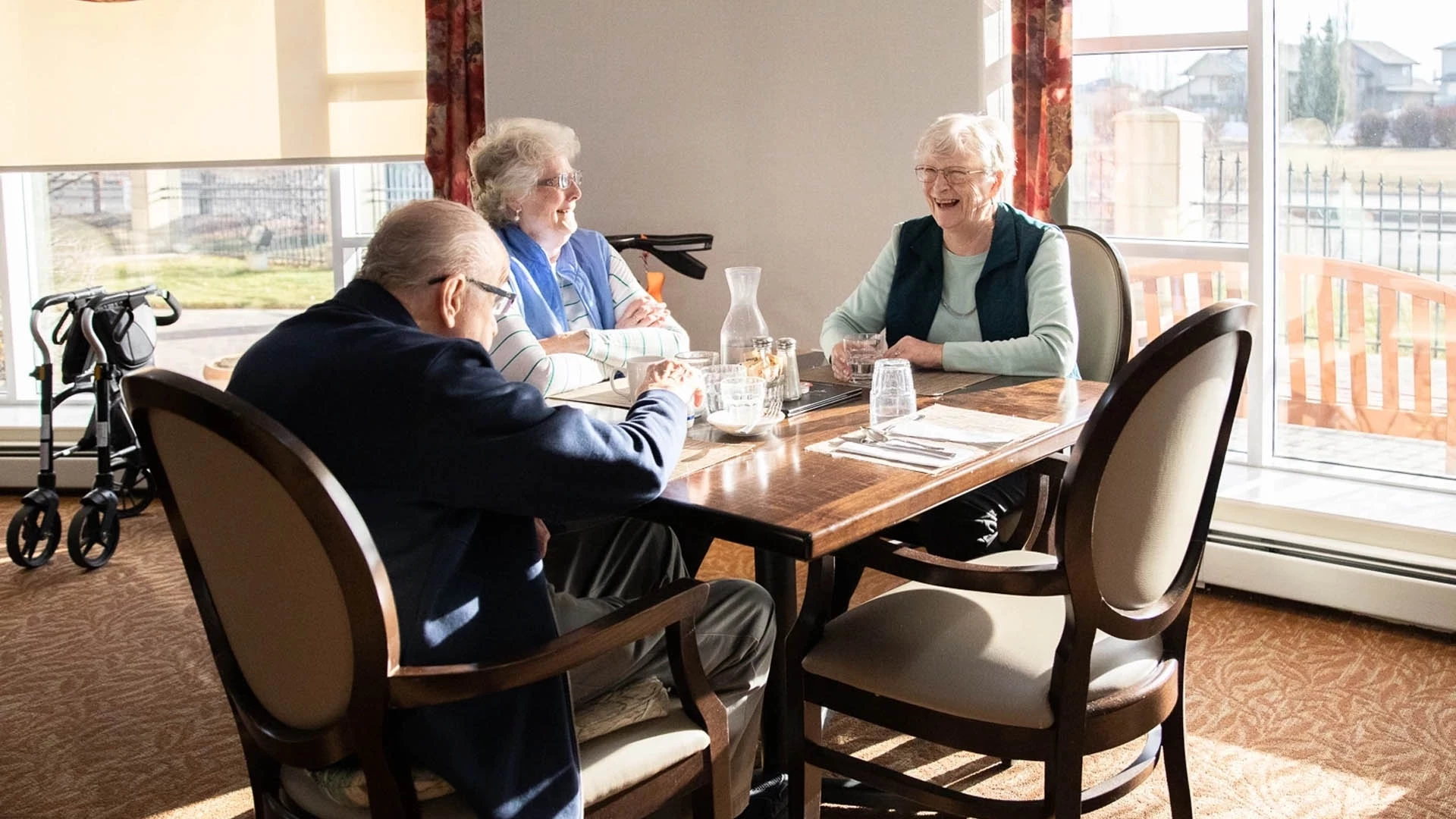 seniors at a dining room laughing