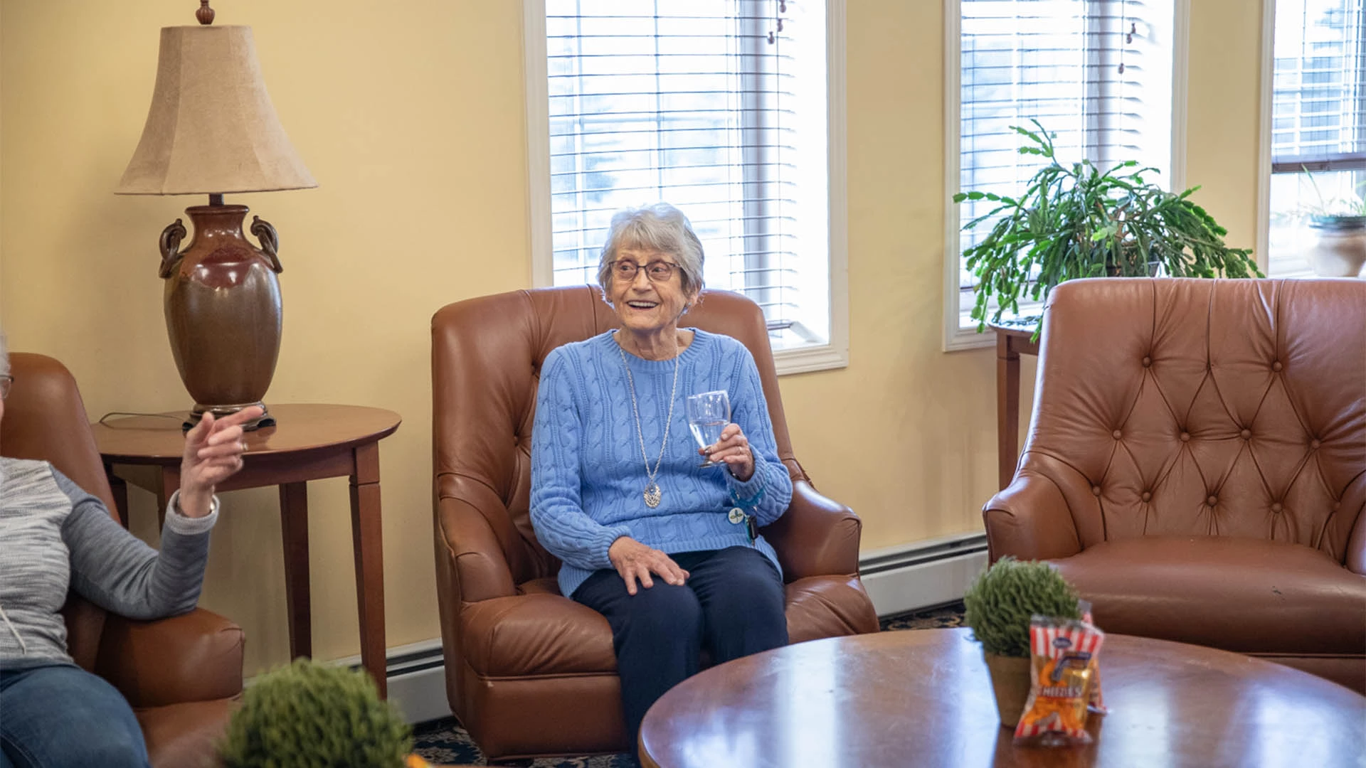 senior lady sitting in a chair and laughing